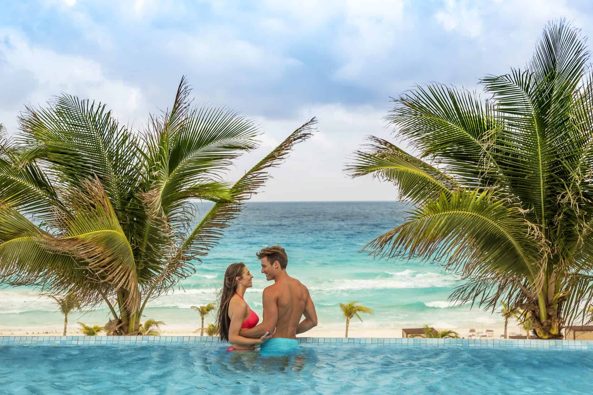 Couple in pool overlooking the beach