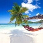 Caribbean beach holiday with hammock on a white sand beach