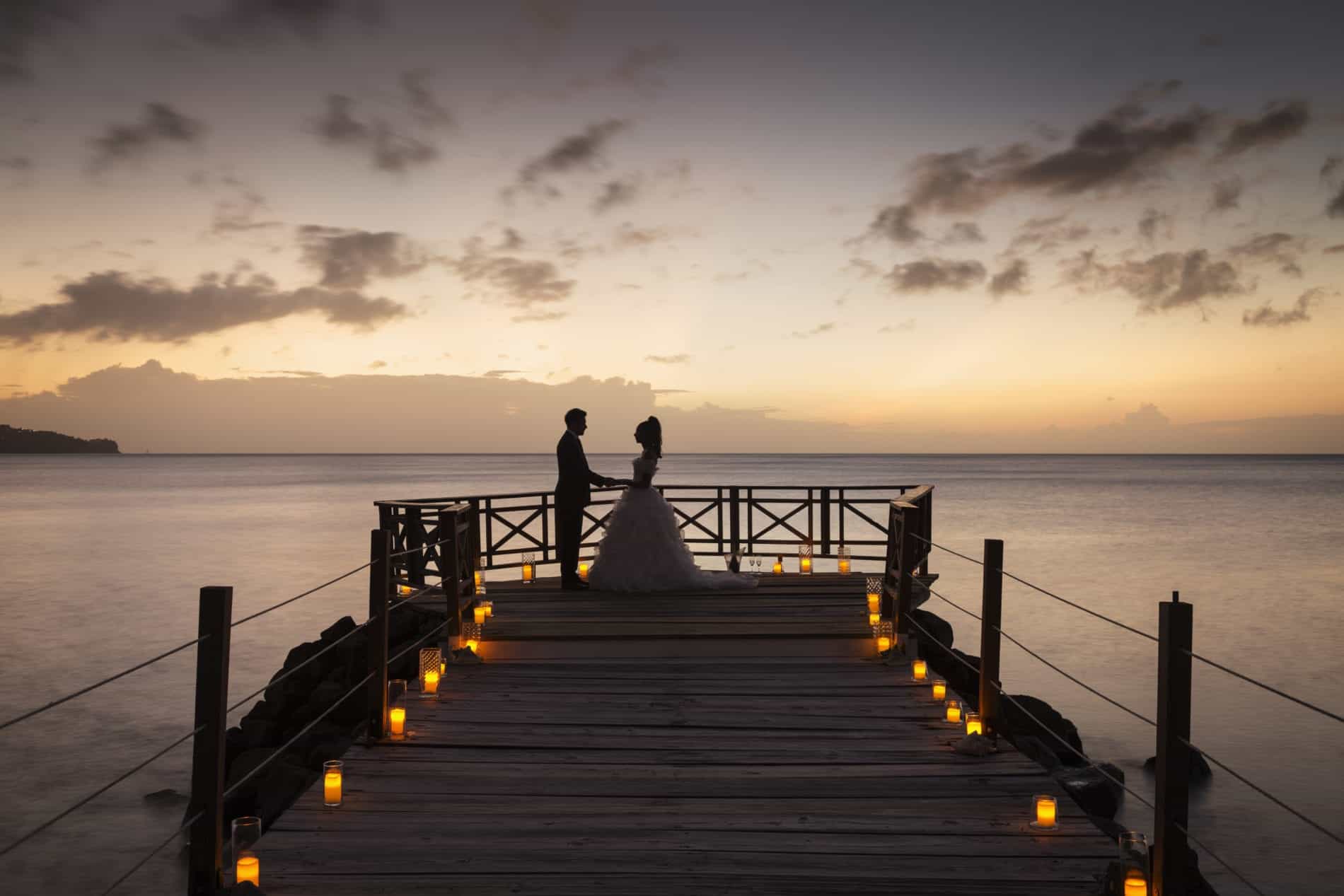 A couple getting married abroad at sunset
